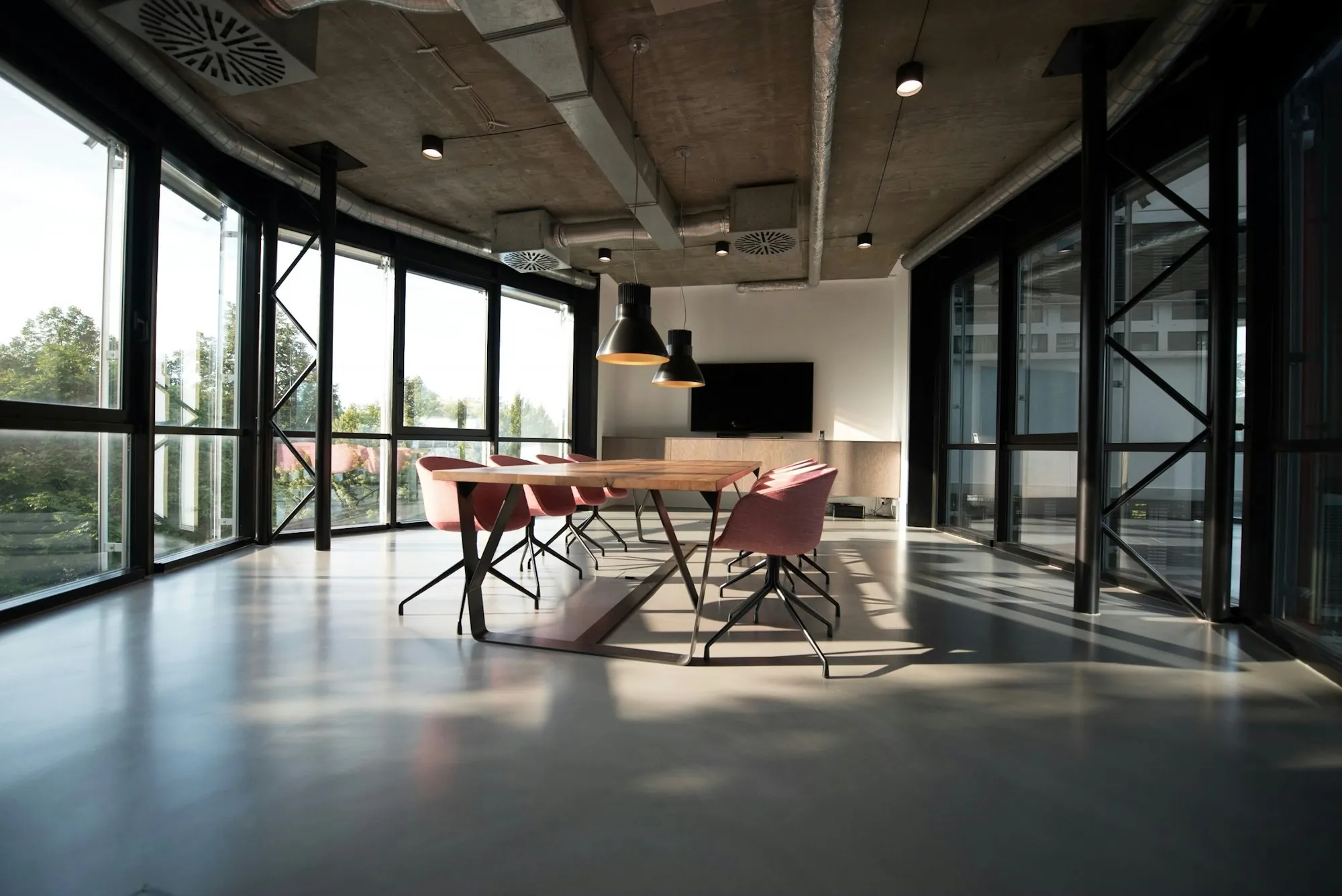Open office with tall windows and a polished concrete floor