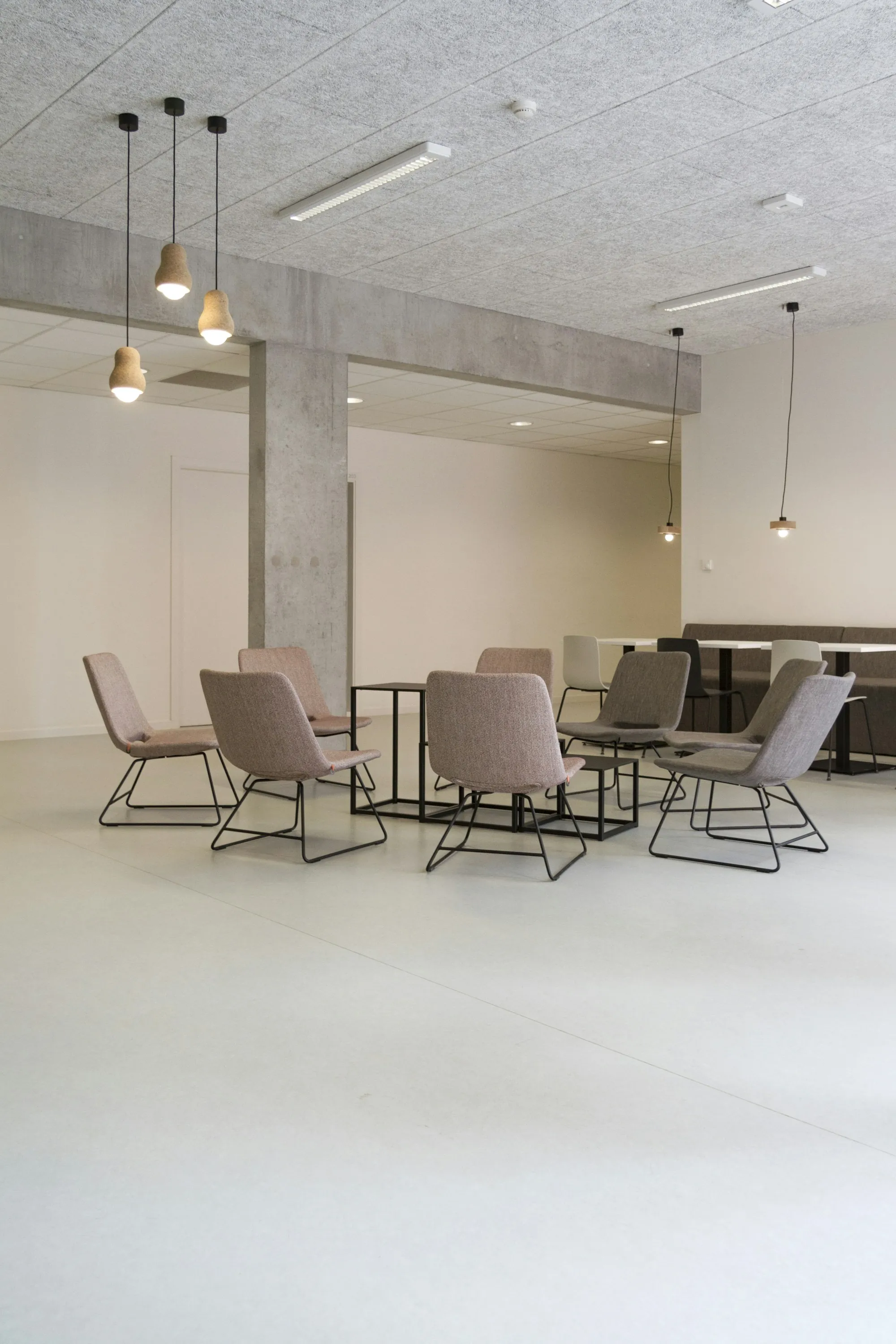 Office seating area with neutral chairs on a light floor